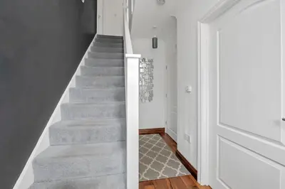 a staircase in a home with a grey carpet at Spacious 5 Bedroom Detached Property with parking in Bury Saint Edmunds