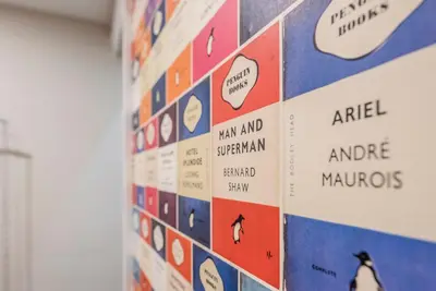 a wall of stickers on a wall at The Book Nook, Woodbridge in Woodbridge