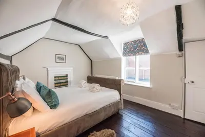 a bedroom with a bed in a room at The Book Nook, Woodbridge in Woodbridge