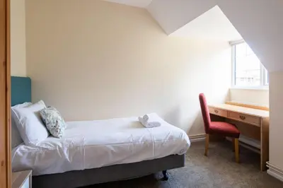 a bedroom with a bed and a desk and a chair at Dolphin Apartment, Thorpeness - Only a short stroll from the Beach, Thorpeness Lake, Country Club and Golf Club in Thorpeness