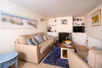 a living room with a couch and a table at Barleys Cottage - Aldeburgh Coastal Cottages in Aldeburgh