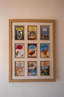 a framed picture of books on a wall at Barleys Cottage - Aldeburgh Coastal Cottages in Aldeburgh