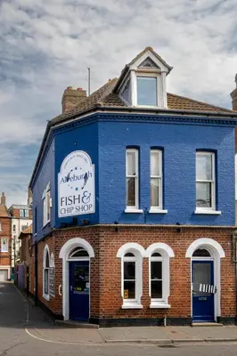 a blue brick building with a sign on it at Barleys Cottage - Aldeburgh Coastal Cottages in Aldeburgh