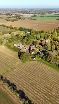 an aerial view of a house in the middle of a field at 'Bramley' Hut on private farm in Charsfield