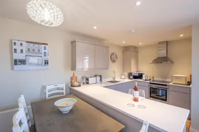 a kitchen with a table and a counter top at 3 King Georges House - Aldeburgh Coastal Cottages in Aldeburgh