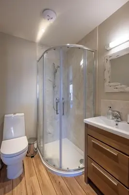 a bathroom with a shower and a toilet and a sink at 3 King Georges House - Aldeburgh Coastal Cottages in Aldeburgh