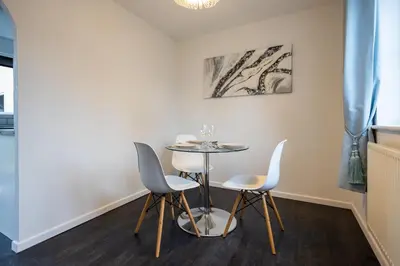 a dining room with a table and two chairs at Hampstead Avenue in Great Clacton