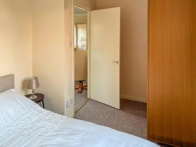 a bedroom with a bed and a door to a closet at Lowal House - Uk46054 in Saffron Walden