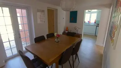 a dining room with a wooden table and chairs at Fully Refurbished 3 bed Victorian Cottage in Tolleshunt D'Arcy in Tolleshunt DʼArcy