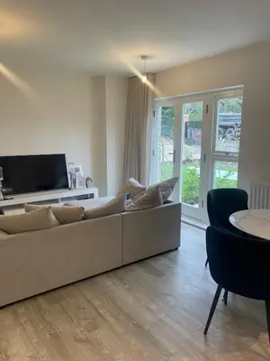 a living room with a couch and a tv at Prestige 1 bed apartment in Shenfield