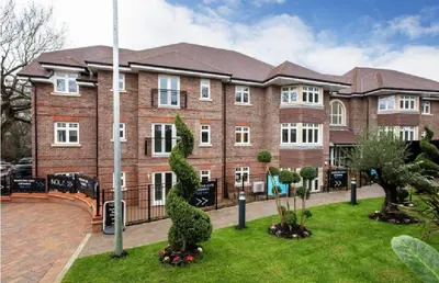 a large brick building with a statue in front of it at Prestige 1 bed apartment in Shenfield