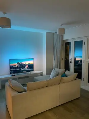 a living room with a couch and a flat screen tv at Prestige 1 bed apartment in Shenfield