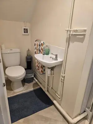 a small bathroom with a toilet and a sink at Barnfield Rooms in Chelmsford