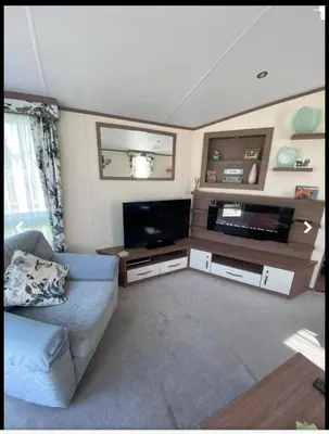 a living room with a couch and a flat screen tv at Weeley Bridge 3 Bedroom Luxury Holiday Home in Weeley