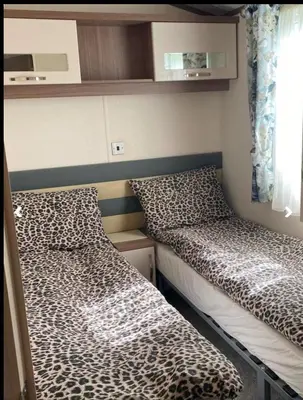 a small room with two beds and a window at Weeley Bridge 3 Bedroom Luxury Holiday Home in Weeley