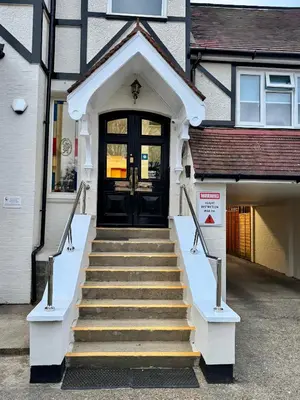 a front door of a building with stairs leading to it at Gidea Park Hotel in Romford