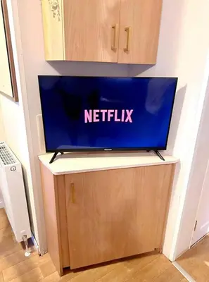 a netflix laptop on top of a table at Harwich - Caravan - Sleeps 10 - Garden - Pool in Harwich