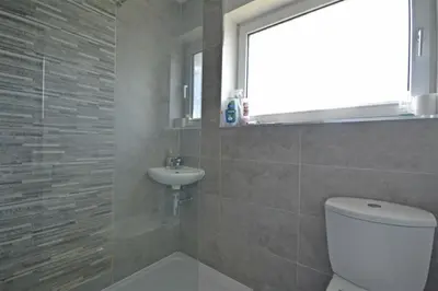 a bathroom with a toilet and a sink at Modern home in historic market town near airport in Saffron Walden