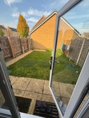a view of a yard from a sliding glass door at OnSiteStays - 4 Large Bedrooms 3 Bathrooms 1 WC Parking Garden & Wifi in Basildon