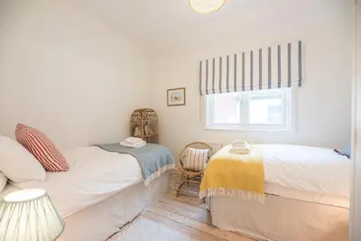 a bedroom with two beds and a window at Sea Holly Cottage, Aldeburgh in Aldeburgh