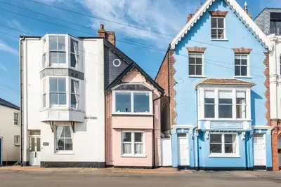 a large blue and white house on a street at Sea Holly Cottage, Aldeburgh in Aldeburgh