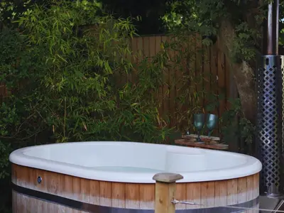 a bath tub sitting in front of a bush at The Pheasant in Great Ellingham