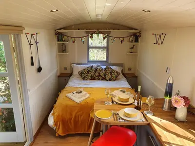 a small room with a bed and a table at The Pheasant in Great Ellingham