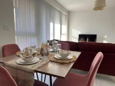 a dining room table with plates and wine glasses at Modern & Elegant with Free Parking & Balcony in Cambourne