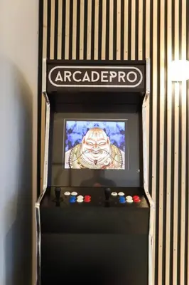 a video game machine with a screen with a character on it at Penthouse with Hot Tub by Cambridge Station in Cambridge
