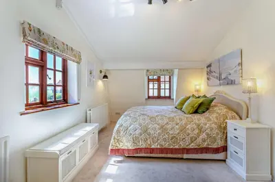 a white bedroom with a bed with green pillows at 1 Bed in Hundon oc-t30616 in Hundon
