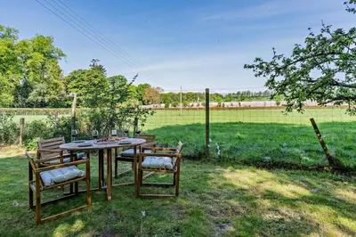a table and chairs in a yard with a field at 1 Bed in Hundon oc-t30616 in Hundon