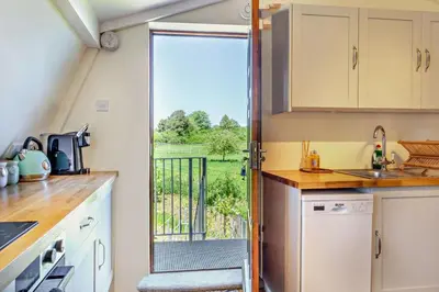 a kitchen with a door leading to a balcony at 1 Bed in Hundon oc-t30616 in Hundon