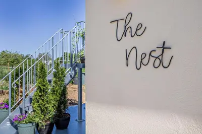 a sign on the side of a building with plants at 1 Bed in Hundon oc-t30616 in Hundon