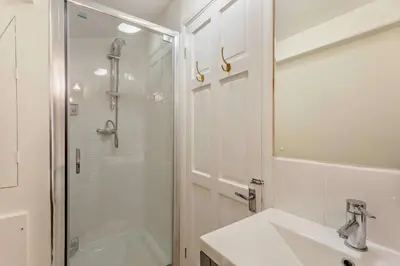 a white bathroom with a shower and a sink at 1 Bed in Hundon oc-t30616 in Hundon