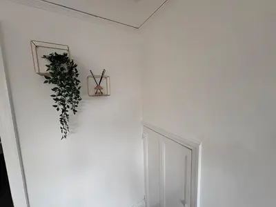 a white wall with a plant in a box on it at Central Chelmsford 2-Bed Apt 5 mins to Station in Chelmsford