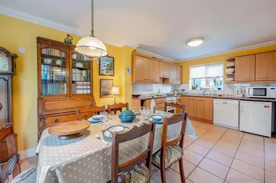 a dining room with a table and a kitchen at 3 Bed in Hingham oc-m29945 in Hingham