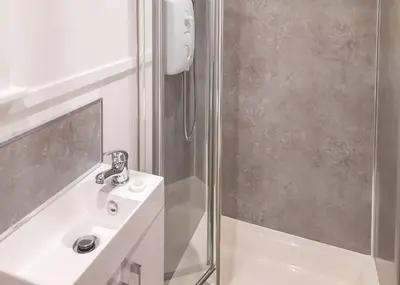 a bathroom with a sink and a shower at Fenview Lakes in Ely