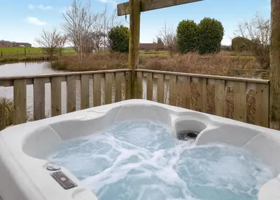 a jacuzzi tub with snow on a fence at Fenview Lakes in Ely