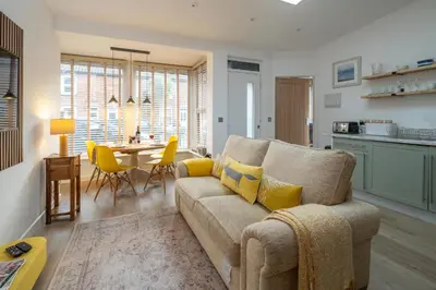 a living room with a couch and a table at Hale House, Leiston - Aldeburgh Coastal Cottages in Leiston