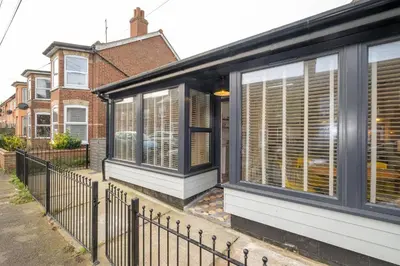 a house with windows and a fence at Hale House, Leiston - Aldeburgh Coastal Cottages in Leiston