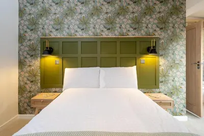 a bedroom with a white bed with a green headboard at Hale House, Leiston - Aldeburgh Coastal Cottages in Leiston
