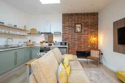 a living room with a couch and a kitchen at Hale House, Leiston - Aldeburgh Coastal Cottages in Leiston