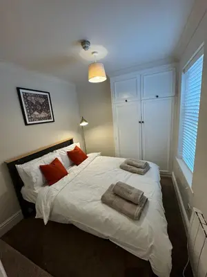 a bedroom with a white bed with towels on it at 1 bed flat in central Cambridge in Cambridge
