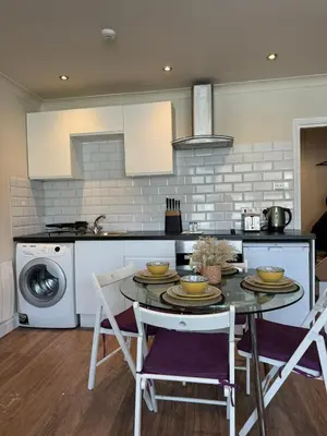 a kitchen with a table and chairs in a kitchen at 1 bed flat in central Cambridge in Cambridge