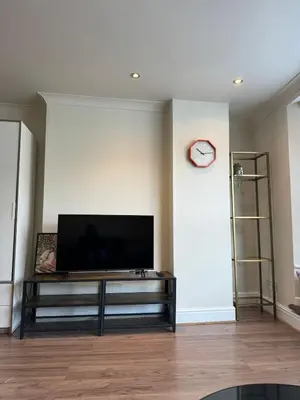 a living room with a flat screen tv on a wall at 1 bed flat in central Cambridge in Cambridge