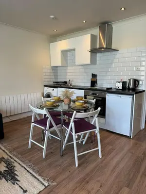 a kitchen with a table and chairs in a kitchen at 1 bed flat in central Cambridge in Cambridge