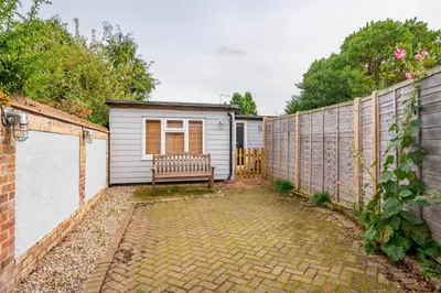 a bench in a backyard with a fence at Holly House Studio, Lavenham in Lavenham