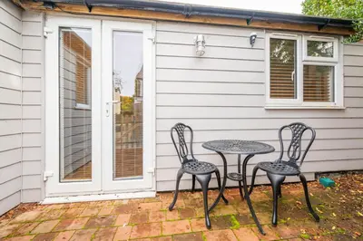 two chairs and a table on a patio at Holly House Studio, Lavenham in Lavenham
