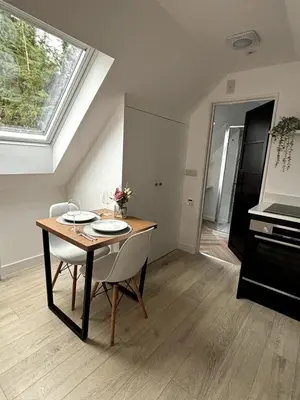 a dining room with a table and a window at The Cartlodge - Studio Loft Apartment in Horringer, Bury St Edmunds in Westley