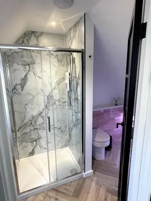 a bathroom with a glass shower with a toilet at The Cartlodge - Studio Loft Apartment in Horringer, Bury St Edmunds in Westley